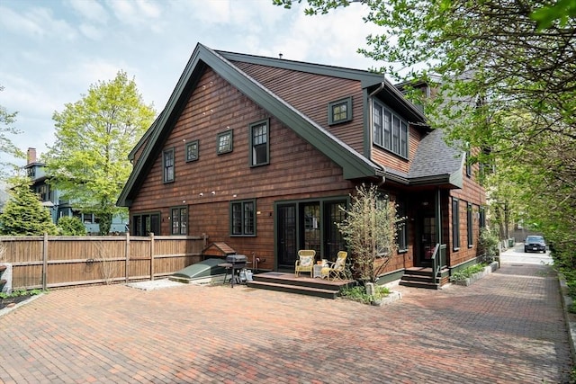 rear view of property featuring fence