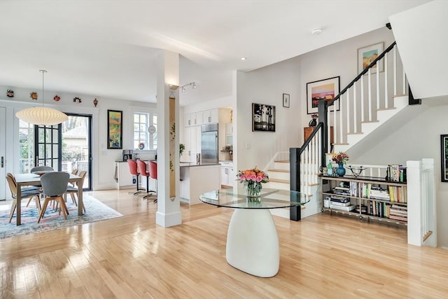 foyer with recessed lighting, baseboards, stairs, and light wood-style flooring