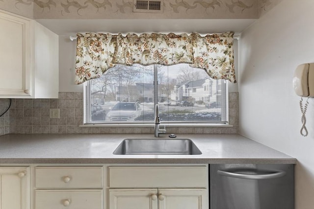 kitchen featuring a healthy amount of sunlight, stainless steel dishwasher, visible vents, and a sink