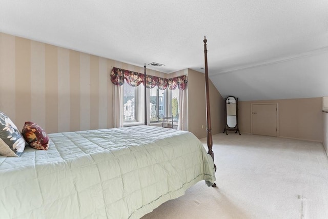 bedroom featuring light carpet, lofted ceiling, visible vents, and wallpapered walls