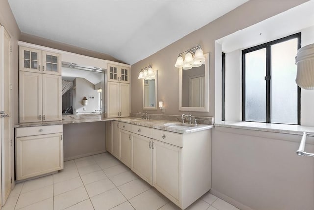 bathroom with vanity, tile patterned flooring, and vaulted ceiling