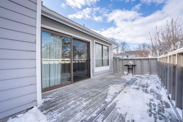 snow covered deck with fence