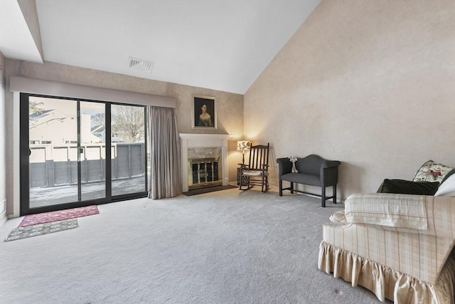 living room with high vaulted ceiling, carpet, a premium fireplace, and visible vents