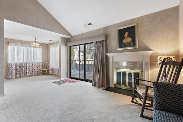 living area featuring a fireplace, high vaulted ceiling, and carpet