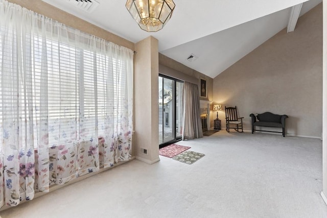 interior space with an inviting chandelier, high vaulted ceiling, and carpet