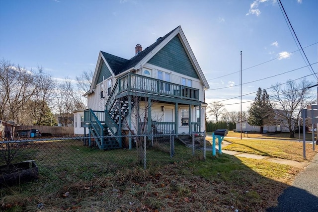 back of house with a lawn