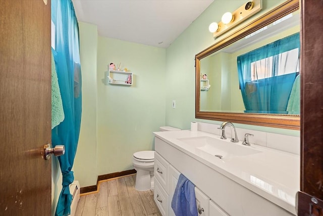 bathroom featuring vanity, hardwood / wood-style flooring, and toilet