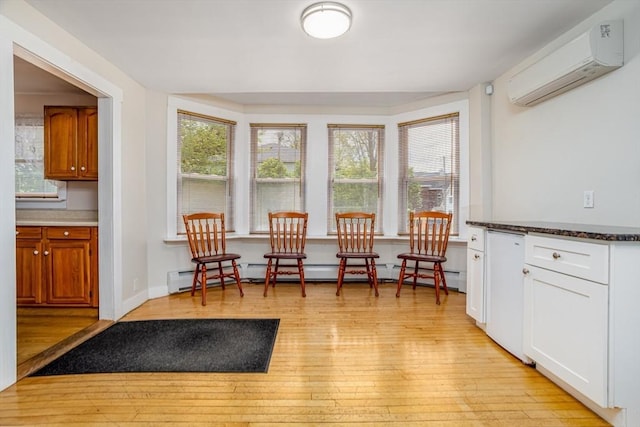 18 Main St, Templeton, MA 01468 - living area with a wall mounted AC, a baseboard heating unit, and light wood-style flooring