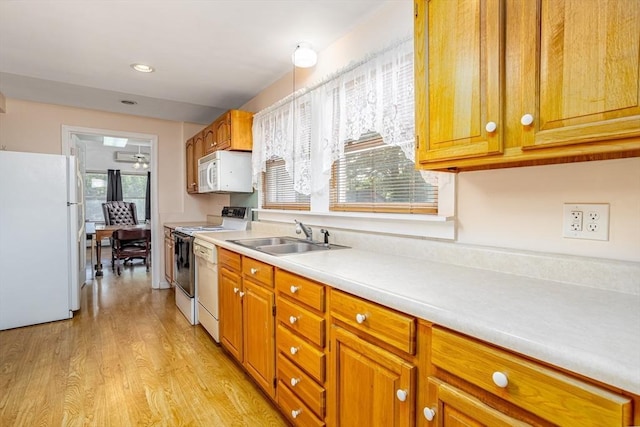 18 Main St, Templeton, MA 01468 - kitchen with white appliances, a sink, light countertops, light wood-type flooring, and brown cabinets