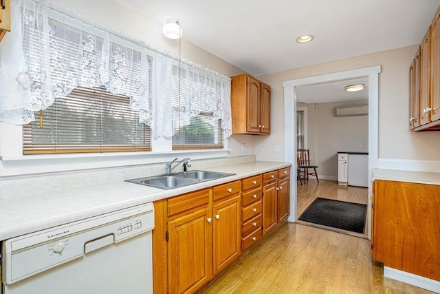 18 Main St, Templeton, MA 01468 - kitchen with white dishwasher, a sink, a wall unit AC, light wood finished floors, and light countertops
