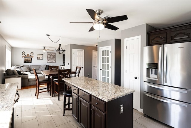 758 Council Oak Way, Dighton, MA 02715 - kitchen featuring stainless steel refrigerator with ice dispenser, a ceiling fan, open floor plan, a kitchen island, and dark brown cabinetry
