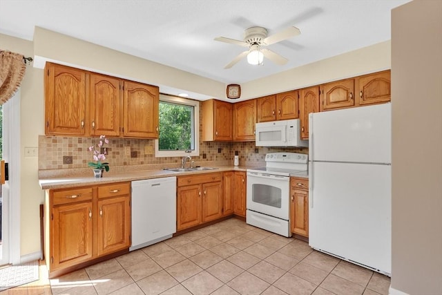 kitchen featuring white appliances, a sink, light countertops, and tasteful backsplash