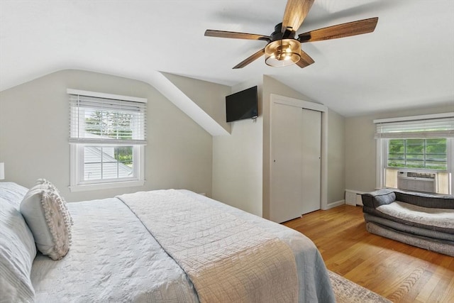 905 Stony Hill Rd, Wilbraham, MA 01095 - bedroom with light wood-type flooring, lofted ceiling, multiple windows, a baseboard heating unit, and cooling unit