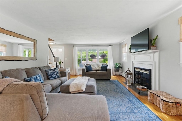 905 Stony Hill Rd, Wilbraham, MA 01095 - living room with wood finished floors, stairs, a fireplace, and baseboard heating