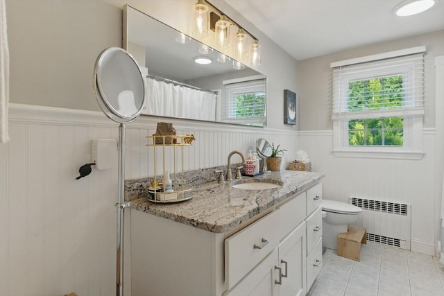 905 Stony Hill Rd, Wilbraham, MA 01095 - full bath featuring radiator heating unit, a wainscoted wall, vanity, tile patterned floors, and toilet