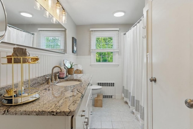 905 Stony Hill Rd, Wilbraham, MA 01095 - bathroom with radiator, tile patterned flooring, toilet, vanity, and a wainscoted wall