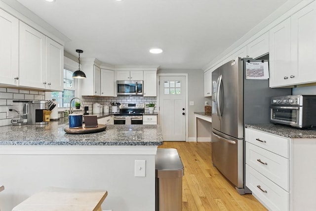 905 Stony Hill Rd, Wilbraham, MA 01095 - kitchen featuring appliances with stainless steel finishes, a peninsula, white cabinetry, and recessed lighting