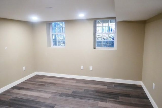 basement with baseboards, wood finished floors, and recessed lighting