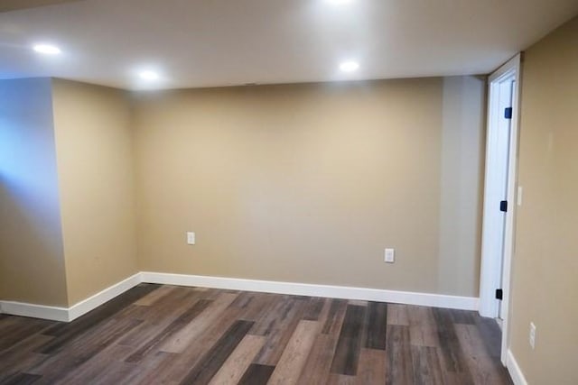 unfurnished room featuring dark wood-type flooring, recessed lighting, and baseboards