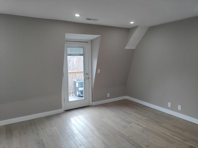 unfurnished room featuring recessed lighting, baseboards, and wood finished floors