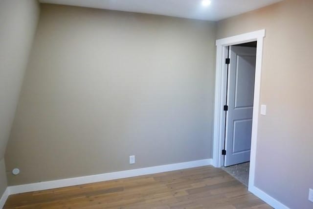 empty room with light wood-type flooring and baseboards