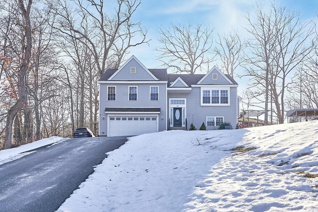 view of front of property featuring an attached garage and aphalt driveway