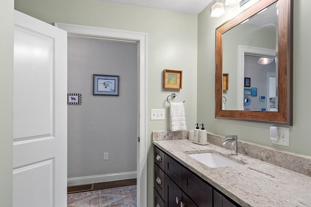 bathroom featuring vanity and baseboards