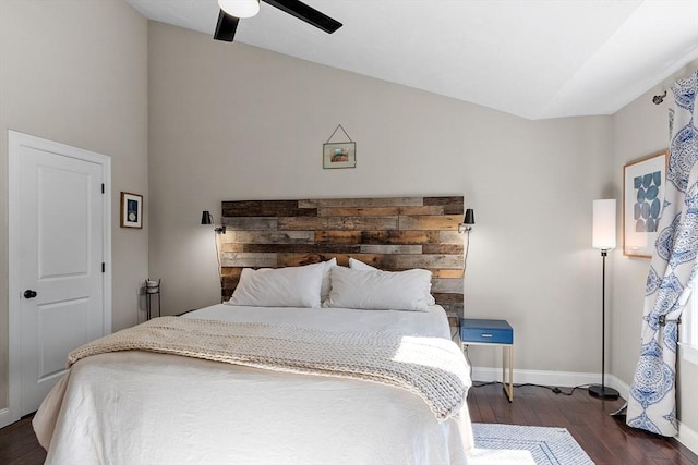 bedroom with lofted ceiling, a ceiling fan, baseboards, and wood finished floors