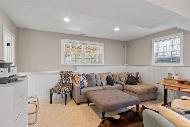 living room with a wainscoted wall, visible vents, a wealth of natural light, and recessed lighting