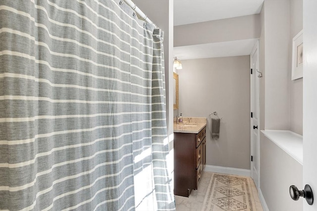 bathroom with baseboards and vanity