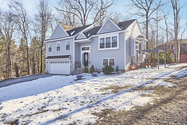 split foyer home featuring a garage and aphalt driveway