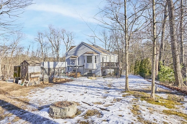 view of front of house with an outdoor structure and a wooden deck