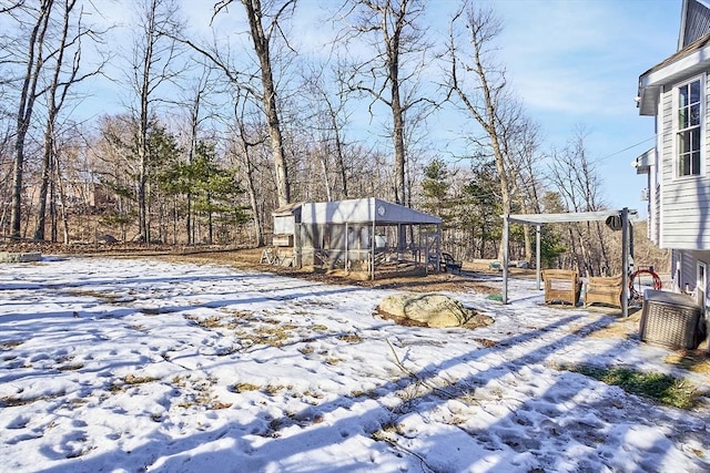 snowy yard featuring a wooden deck