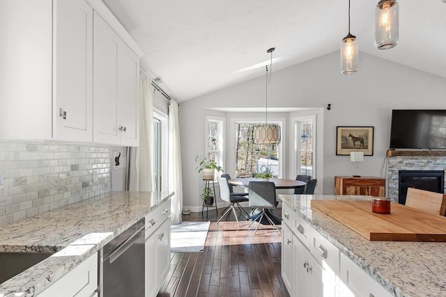 kitchen featuring white cabinets, light stone countertops, dark wood finished floors, and dishwasher