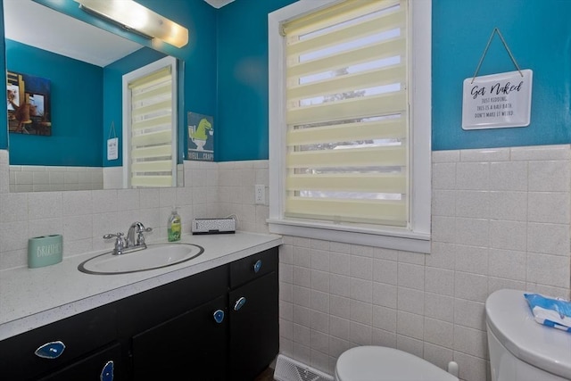 half bath featuring visible vents, plenty of natural light, and toilet