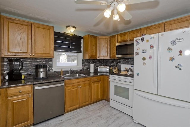 kitchen with tasteful backsplash, appliances with stainless steel finishes, brown cabinetry, and a sink