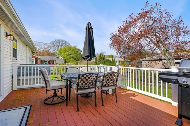 deck with a residential view and outdoor dining area