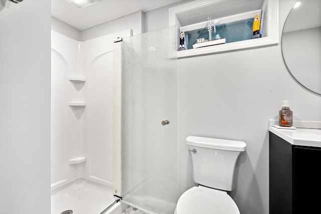 full bath featuring vanity, a stall shower, and toilet