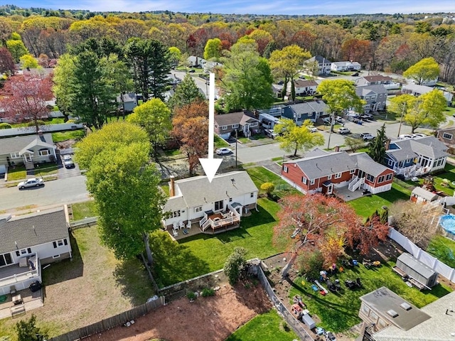 drone / aerial view with a residential view and a forest view