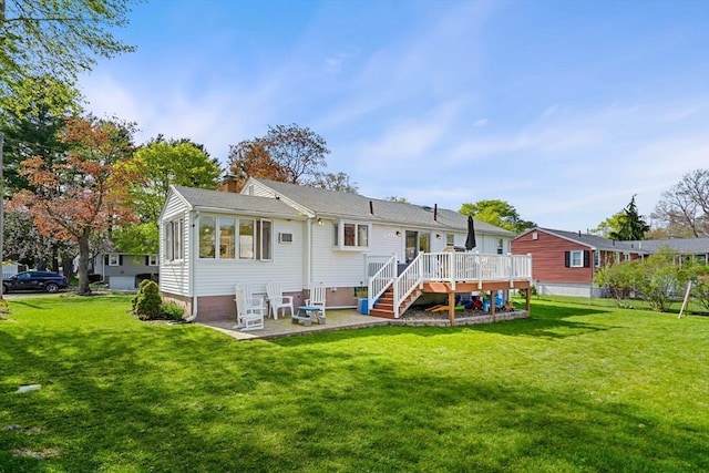 back of house with a deck, stairway, a chimney, a patio area, and a yard
