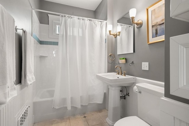 bathroom featuring toilet, shower / bath combo, tile patterned flooring, and radiator heating unit