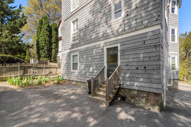 back of house with entry steps and fence