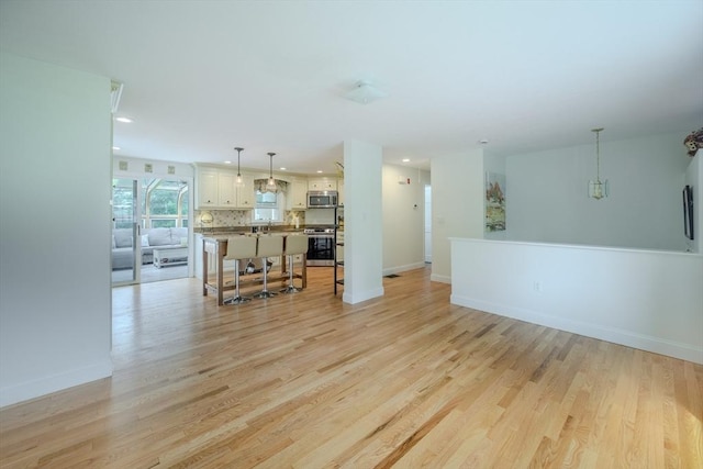 61 Wright Rd, Ayer, MA 01432 - unfurnished living room featuring light wood finished floors and recessed lighting