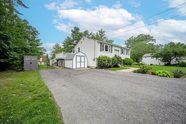 61 Wright Rd, Ayer, MA 01432 - view of front of house featuring a shed, a front lawn, asphalt driveway, and stairs