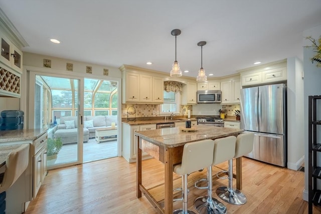 61 Wright Rd, Ayer, MA 01432 - kitchen featuring stainless steel appliances, tasteful backsplash, pendant lighting, light stone counters, and recessed lighting
