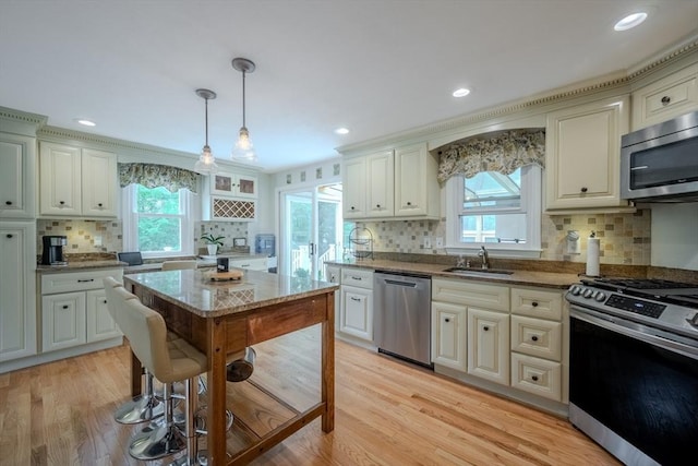 61 Wright Rd, Ayer, MA 01432 - kitchen with appliances with stainless steel finishes, decorative backsplash, healthy amount of natural light, light stone countertops, and recessed lighting