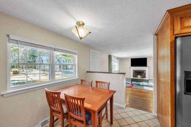 tiled dining space featuring a wealth of natural light