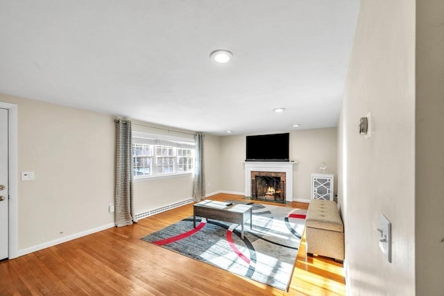 living room featuring hardwood / wood-style flooring and a baseboard radiator