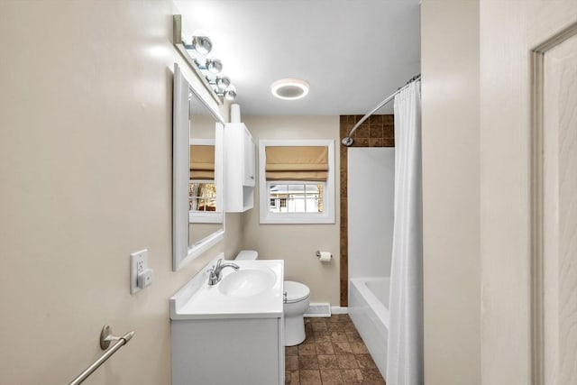 full bathroom featuring toilet, vanity, and shower / bath combination with curtain