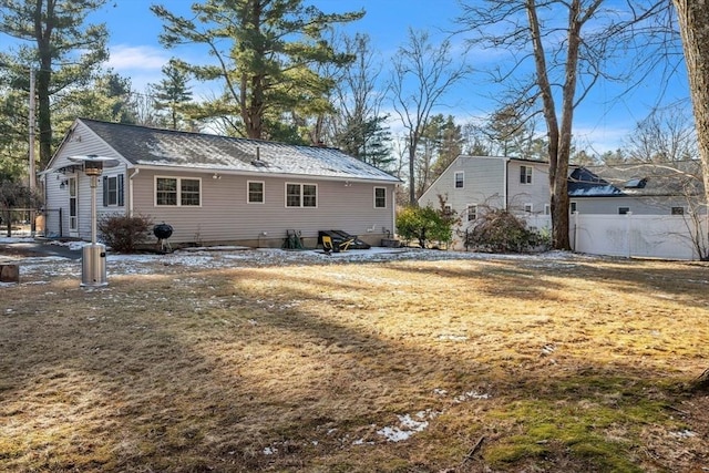 rear view of house featuring a yard